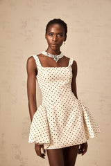 Geneviève neutral colored mini dress with polka dot pattern and puff sleeves