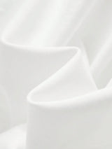 This stunning white dress features a soft, flowing fabric that drapes gracefully, creating an elegant and breathable fit.