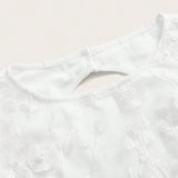 Delicate and chic, this white dress features intricate floral embroidery that adds a touch of elegance to its simple design..