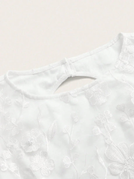 This delicate white dress features intricate floral embroidery, perfect for a romantic occasion. The elegant fit and.