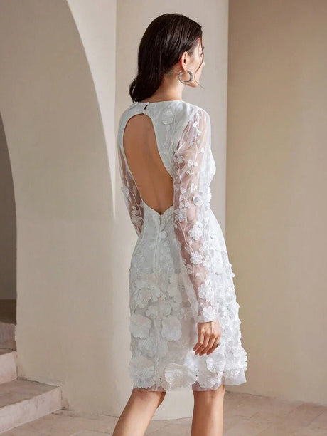 This elegant white dress features delicate floral embroidery and a playful open back that adds a touch of sophistication to.