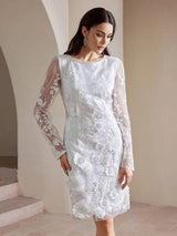 Elegant and intricately designed, this white dress features long sheer sleeves adorned with delicate floral embroidery,.