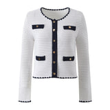 White knit cardigan with navy accents and gold buttons paired with a matching A-line skirt featuring a flared hem
