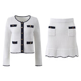 White knit cardigan with navy accents and gold buttons paired with a matching A-line skirt featuring a flared hem