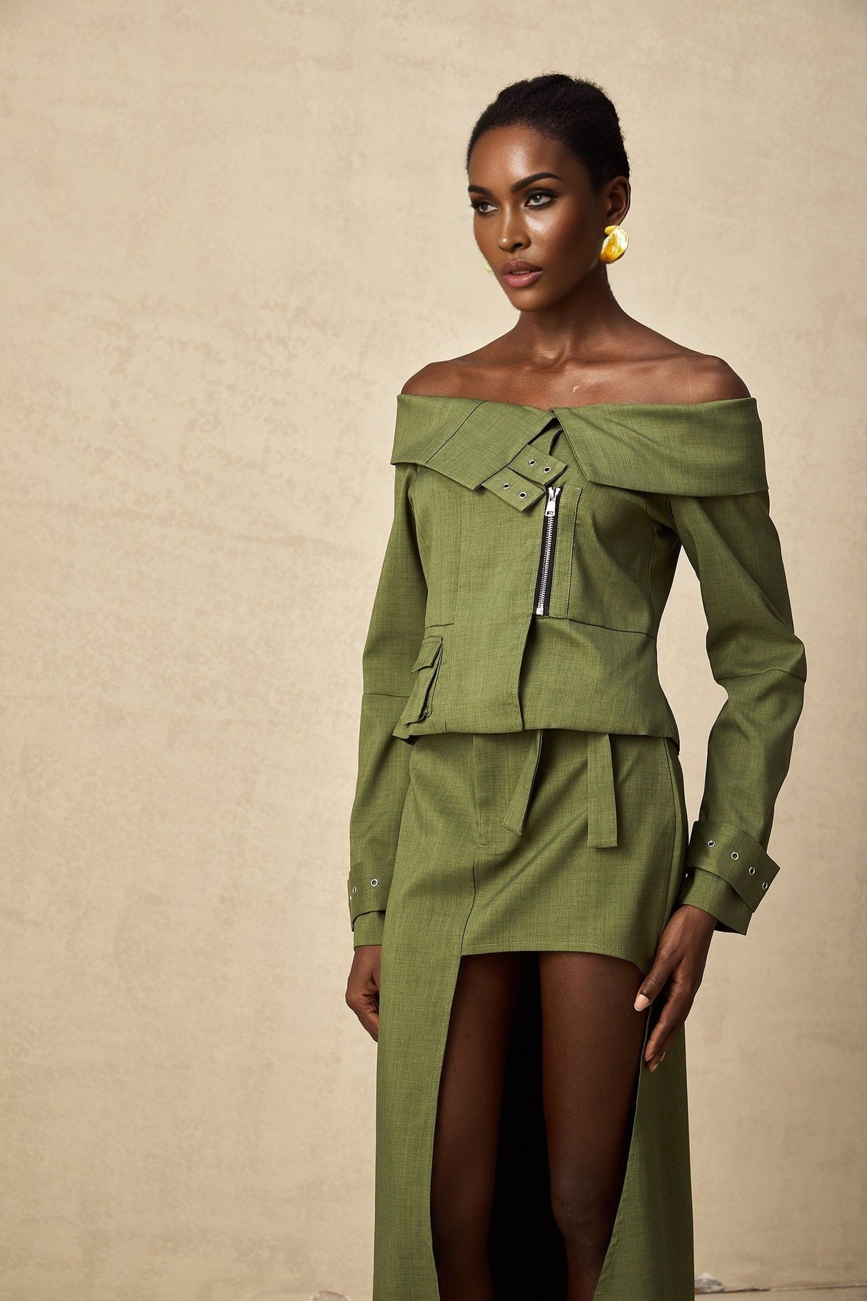 Green asymmetric jacket and skirt set named Elena featuring matching design elements