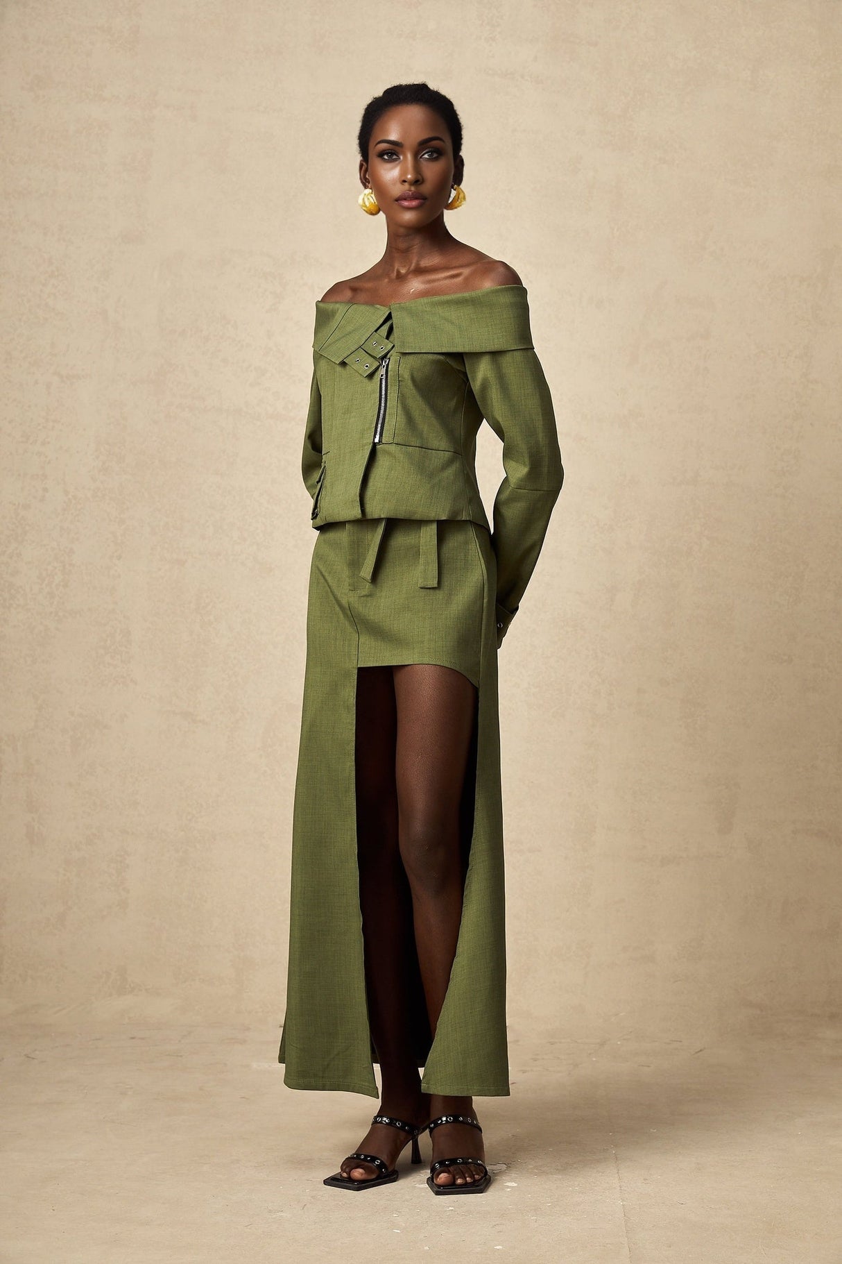 Green asymmetric jacket and skirt set named Elena featuring matching design