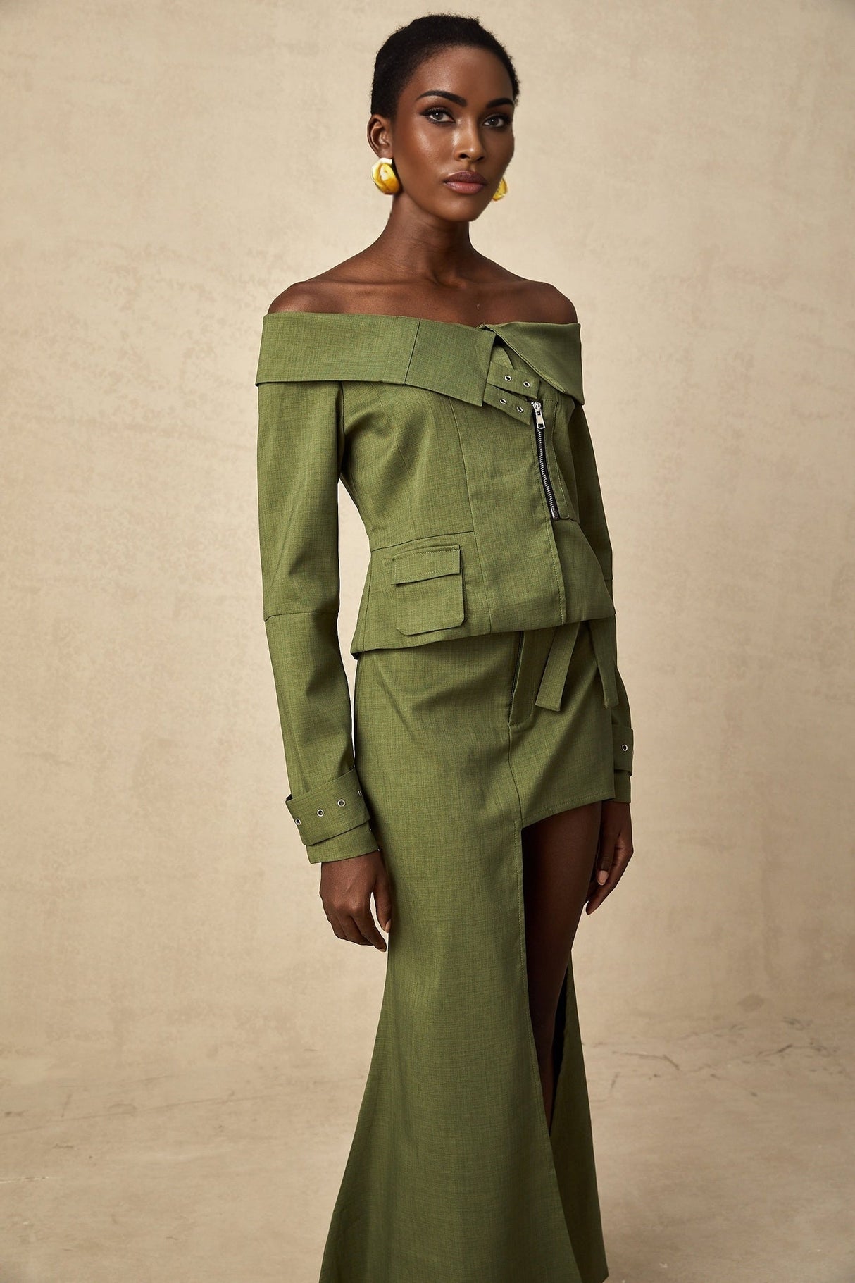 Green asymmetric jacket and skirt set named Elena featuring matching design