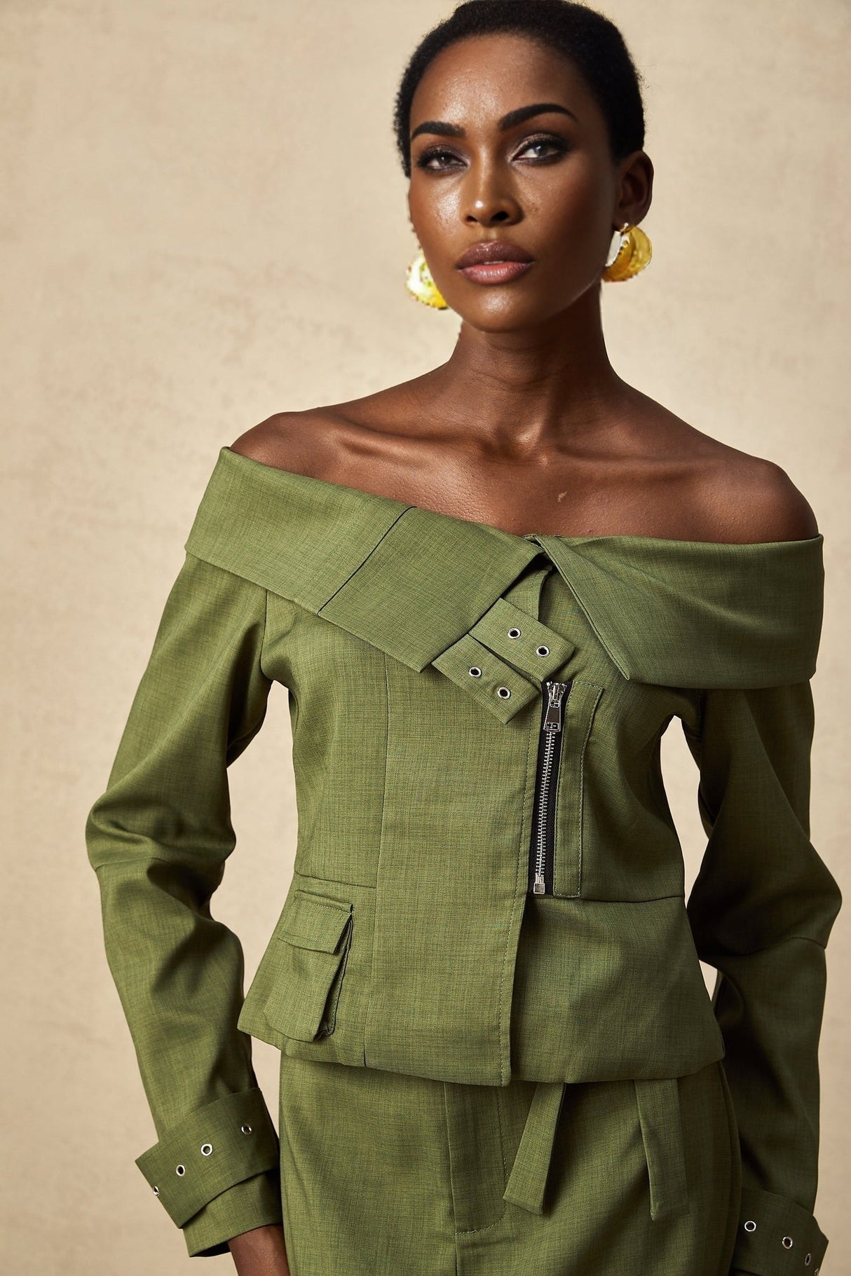 Green asymmetric jacket and skirt set named Elena featuring matching design