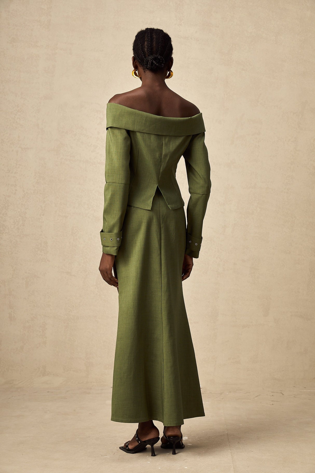 Green asymmetric jacket and skirt set with matching design called Elena