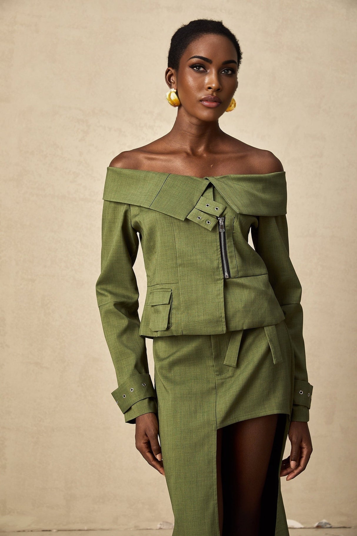 Green asymmetric jacket and skirt set with matching design called Elena