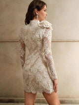 This elegant cream lace dress features a fitted silhouette with long sleeves and delicate floral patterns, creating a.