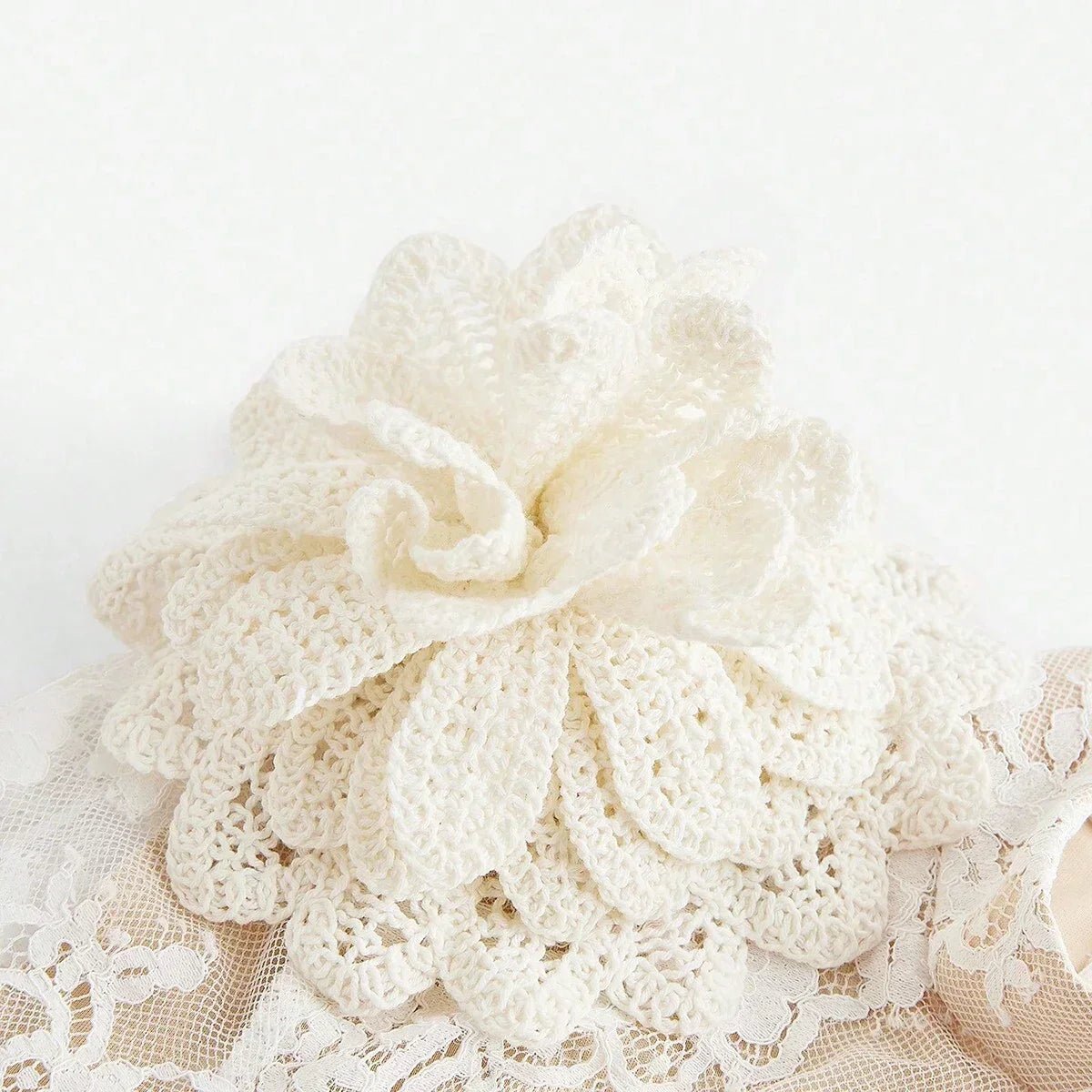 This elegant white dress features a delicate lace overlay adorned with a beautiful crochet floral accent, adding a touch of.