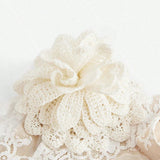 This elegant white dress features a delicate lace overlay adorned with a beautiful crochet floral accent, adding a touch of.