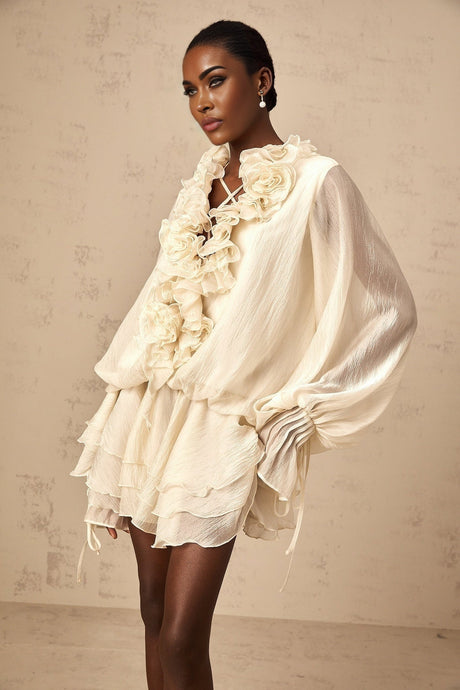Heres a simple alt text for the product image based on the title without any punctuation or special characters

Neutral colored short tiered dress with floral applique details called Zephyrine