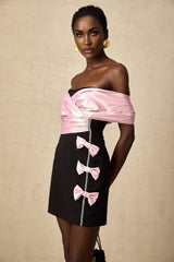Heres a simple alt text for the product image based on the title

Young woman wearing a short colorblocked dress with a bow detail