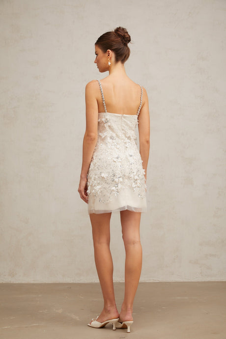 Heres a simple alt text for the product image based on the title

Young woman wearing a short sparkling dress with sequin embellishments shimmering under studio lights
