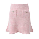 Pastel pink knit cardigan with lace collar and crystal buttons paired with a matching flared skirt