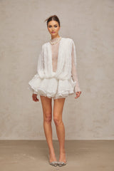 Isoline white lace matching set featuring a semi sheer top shorts and dress laid out on a plain background