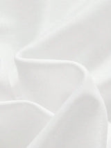 Luxurious and flowing, this elegant white dress is crafted from soft fabric that drapes beautifully, creating a flattering.
