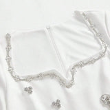 This elegant white dress features a delicate floral beaded neckline that adds a touch of sparkle, perfect for special.