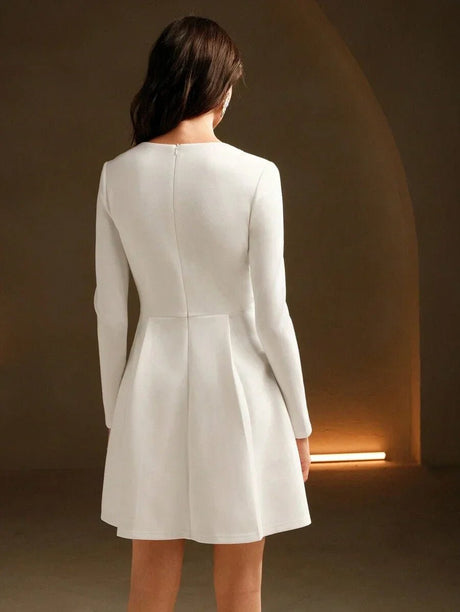 This elegant white dress features a sophisticated silhouette with long sleeves and a flattering fit-and-flare design,.