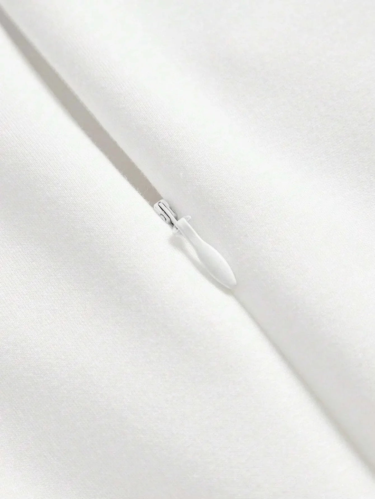 This elegant white dress features a sleek, fitted design that exudes timeless sophistication, made from a soft, smooth.