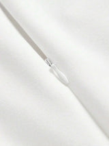 This elegant white dress features a sleek, fitted design that exudes timeless sophistication, made from a soft, smooth.