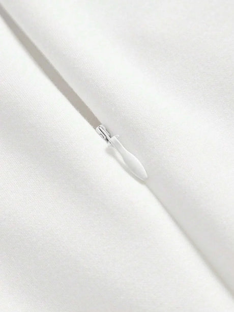 This elegant white dress features a sleek, fitted design that exudes timeless sophistication, made from a soft, smooth.