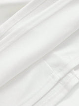 This elegant white dress features a sleek, form-fitting silhouette crafted from soft, breathable fabric, perfect for both.