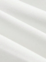 A soft, luxurious white dress crafted from a breathable cotton blend features a flattering fitted silhouette that gently.