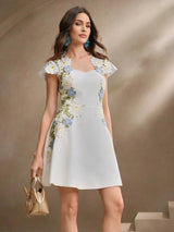 This elegant white dress features delicate floral embroidery in shades of blue and yellow, accentuating its charming fitted.