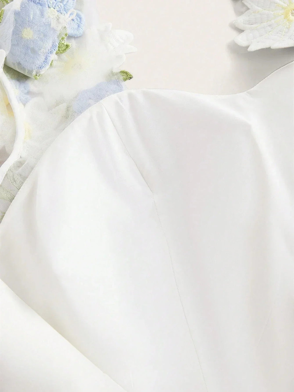 Float into elegance with this creamy white dress, featuring delicate floral embellishments and subtle sheer details that add.