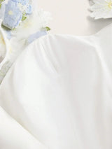 Float into elegance with this creamy white dress, featuring delicate floral embellishments and subtle sheer details that add.