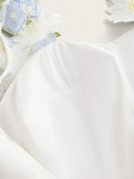 Float into elegance with this creamy white dress, featuring delicate floral embellishments and subtle sheer details that add.