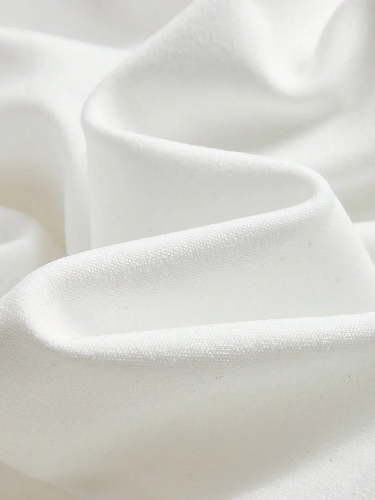 Luxuriously soft and elegantly draped, this pristine white fabric showcases a smooth texture reminiscent of delicate satin..