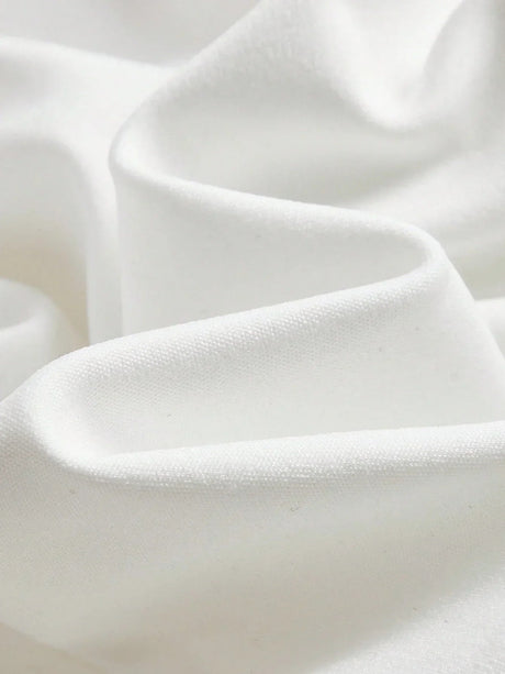 Luxuriously soft and elegantly draped, this pristine white fabric showcases a smooth texture reminiscent of delicate satin..