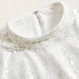 Elegant and shimmering, this white dress features a subtle sequin overlay that catches the light beautifully, adding a touch.