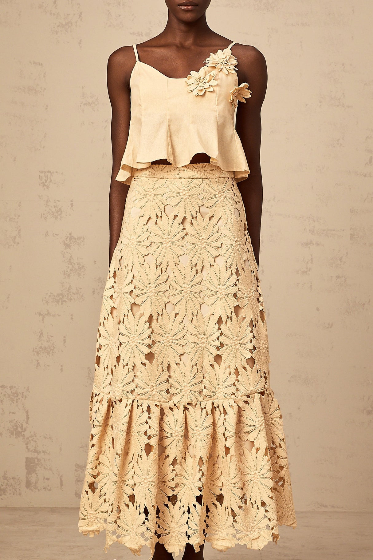 Khaki colored matching set with a flared top and skirt featuring cutout details