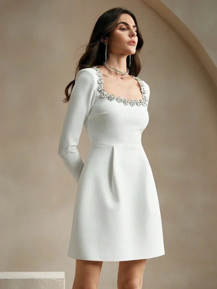 Elevate your wardrobe with this stunning white mini dress, featuring a chic square neckline adorned with delicate floral.
