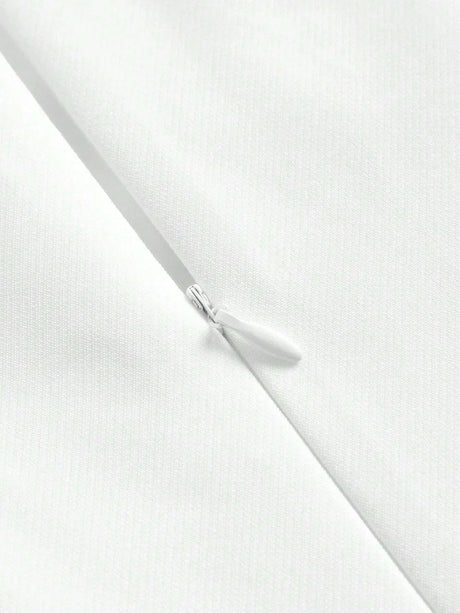 This elegant white dress features a sleek, fitted silhouette and a zipper closure for added convenience, showcasing a.