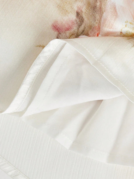 Delicate and flowy, this ivory dress features beautiful floral prints with soft pink accents, perfect for a romantic look..