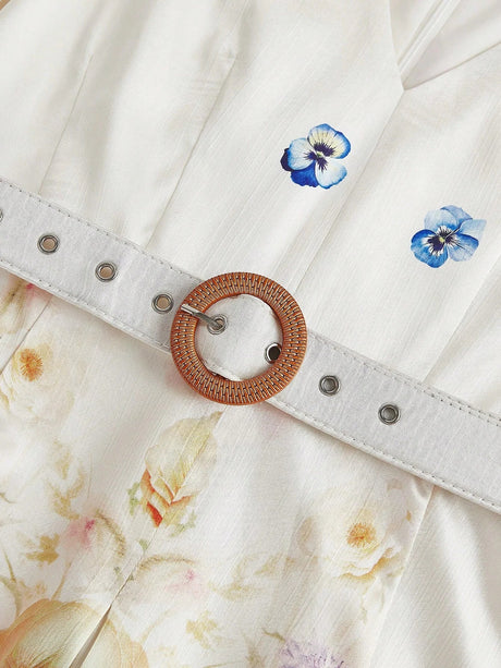 This charming white dress features delicate floral prints in soft pastel hues, complemented by elegant blue pansy accents..