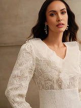 Elegant and ethereal, this white dress features delicate embroidered patterns and flowing sleeves that enhance its soft,.