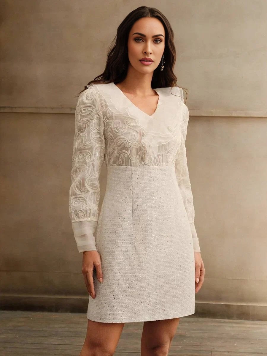 This elegant white dress features a flattering fit-and-flare silhouette, complemented by intricate embroidered sleeves and a.