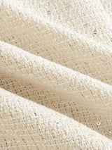 This elegant dress features a soft ivory hue, crafted from a textured fabric that adds a sophisticated touch. Adorned with.