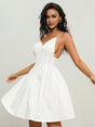 This charming white dress features a flirty A-line silhouette with delicate spaghetti straps and a flattering plunging.