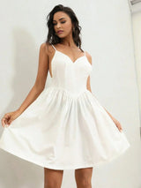 This elegant white dress features a flattering fitted bodice with a sweetheart neckline and delicate spaghetti straps,.