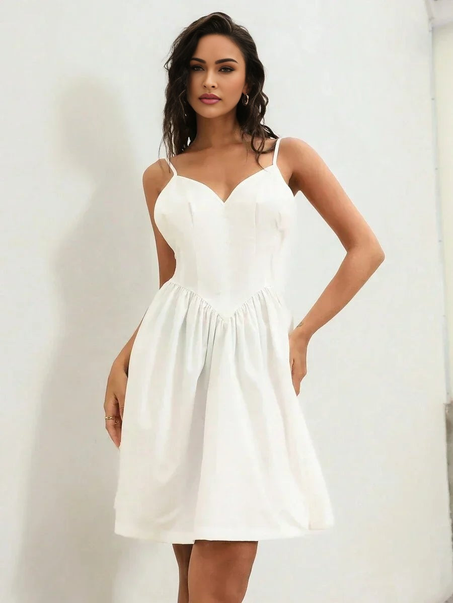 This elegant white dress features a flattering sweetheart neckline and delicate spaghetti straps, creating a romantic.