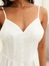 Elegant and lightweight, this stunning white dress features a flattering V-neckline and delicate spaghetti straps, perfect.