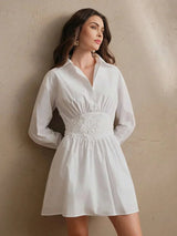This chic white dress features a flattering fit-and-flare silhouette, accentuated by delicate floral embroidery at the waist.